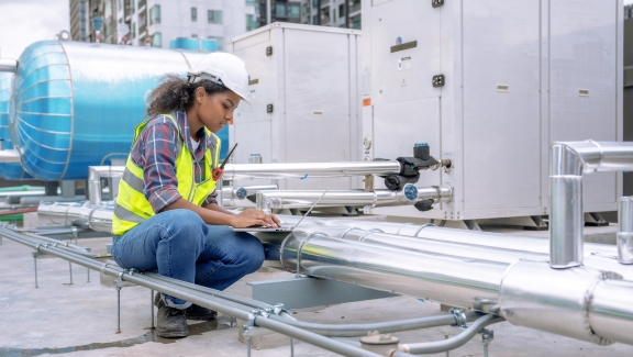 A woman contractor working on a HVAC equipment