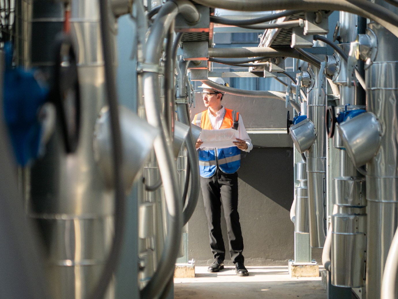 An employee working in a rooftop cooling tower